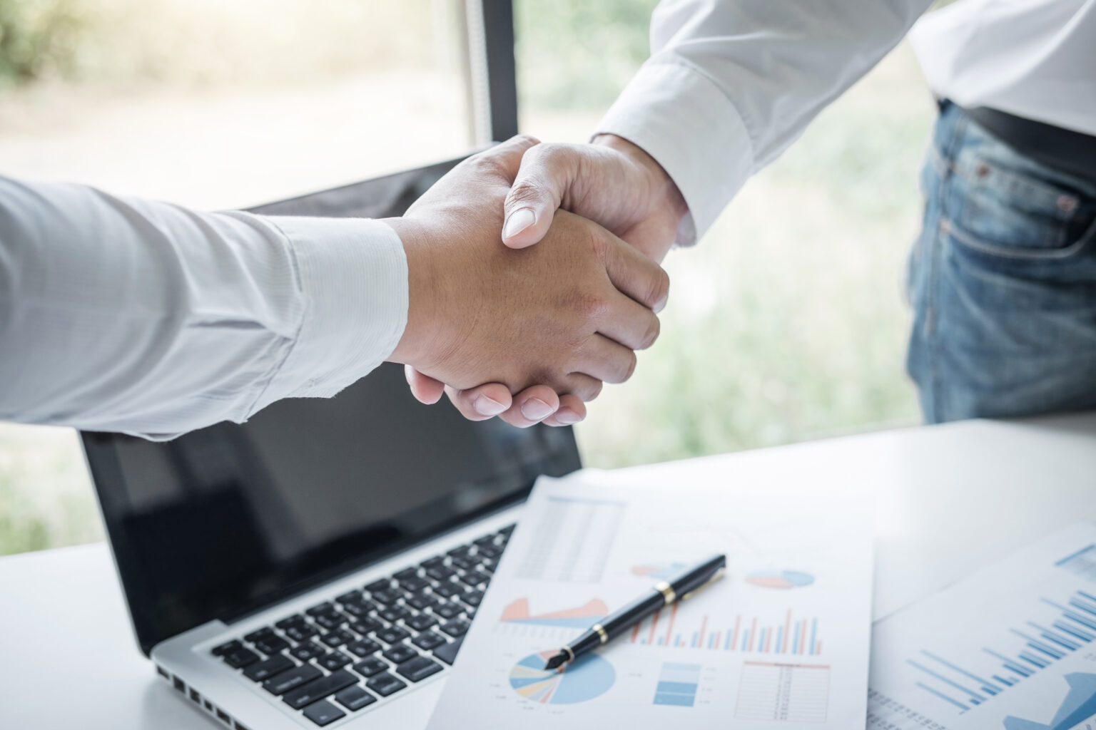 Finishing up a meeting, Business handshake after discussing good deal of Trading to sign agreement and become a business partner, contract for both companies, Successful businessman handshake.